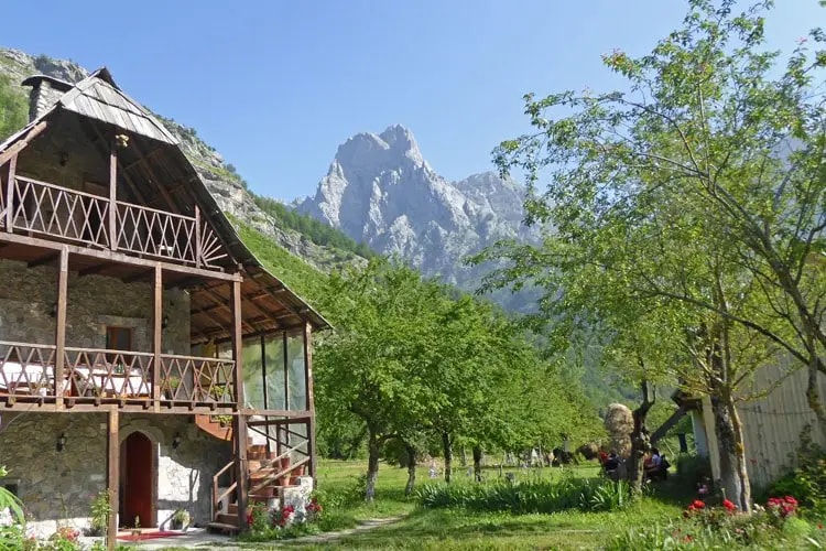 Hikers relaxing outside a guest house in the Albanian mountains